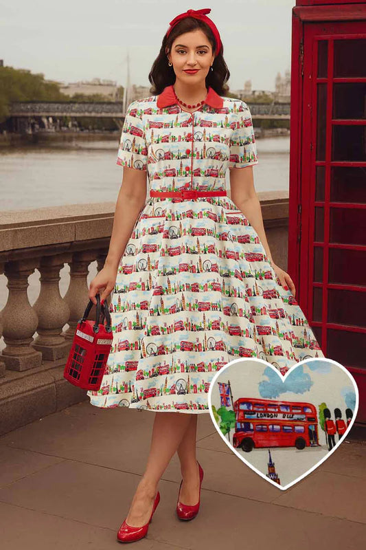 Woman wearing a vintage-style dress with a red telephone box and double-decker bus pattern, standing near a red phone booth.