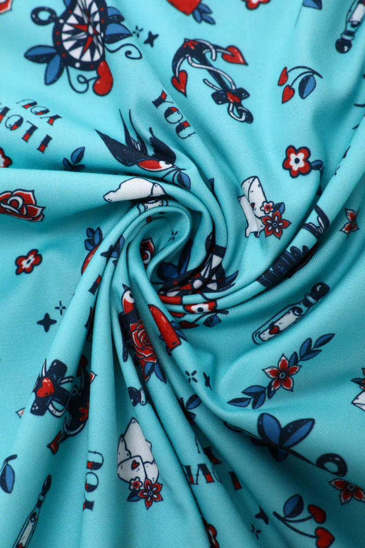 Turquoise fabric with colorful tattoo-style designs, fabric close up