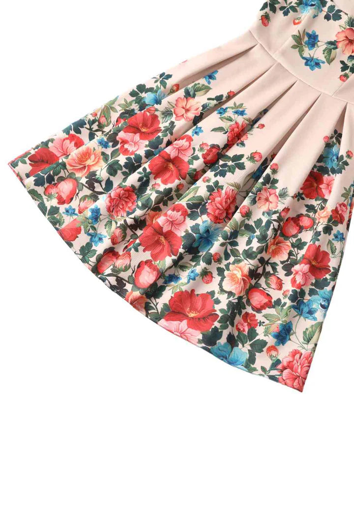 Floral swing dress with a floral pattern on a white background, close up of skirt.