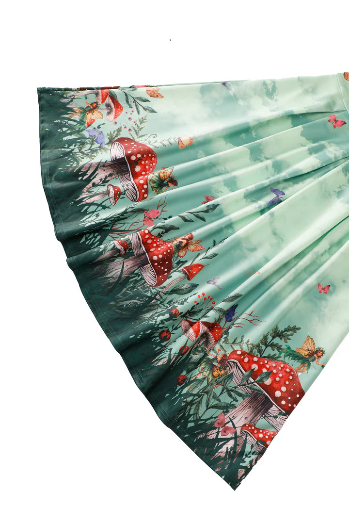 Vintage Pleated Skirt with forest design featuring mushrooms and fairies on a white background, skirt close-up.