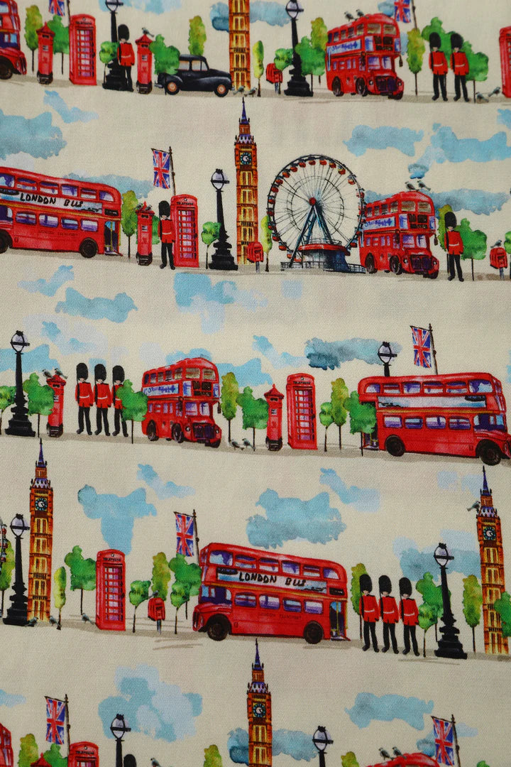 Pattern of London-themed fabric dress with red double-decker buses, Big Ben, and other iconic elements.